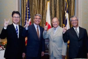 At the signing ceremony, partners on the next-generation energy efficient data center give the "Hook 'em, Horns" hand sign. From left to right: NTTF Senior Executive Vice President Atsushi Ichihoshi, UT Austin President Gregory L. Fenves, Texas Secretary of State Carlos Casco, NEDO Executive Director Fumio Ueda. Photo by Marsha Miller.