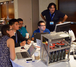 XSEDE Scholar Paul Delgado, top right, works with his team at the XSEDE13 conference computer modeling competition in San Diego in July of 2013. Image credit: XSEDE Scholar's Program.