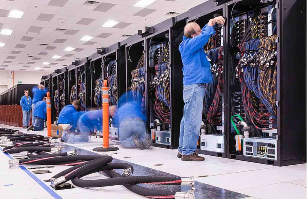 Technicians prepare the first row of cabinets for the pre-exascale Trinity supercomputer at Los Alamos National Laboratory, where a team from Lawrence Livermore National Laboratory deployed its new Spack software packaging tool. Photo courtesy of Los Alamos National Laboratory.