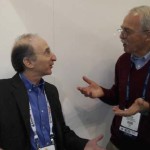 Dr. Saul Perlmutter (left) holds an animated conservation with John Kirkley at SC13. Photo by Sharan Kalwani, Fermilab