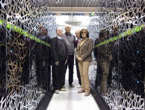 CEA-F4E CSC team standing between a section of the “Helios” supercomputer: from left to right, Jacques David, François Robin, Jacques Noé (CEA) and Susana Clement Lorenzo (F4E).
